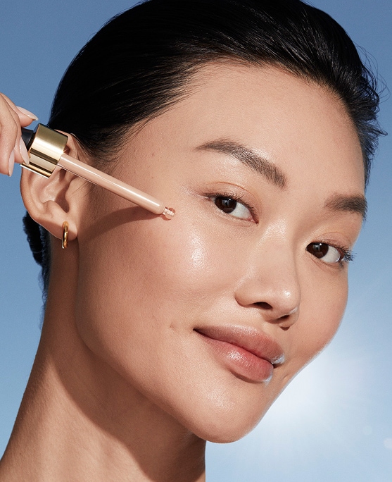 photo of woman with passport makeup applying futurist skintint serum