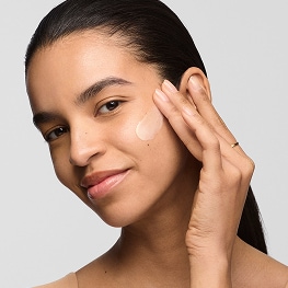 photo of woman with dry skin routine applying moisturizer to face