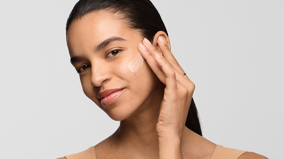 photo of woman with dry skin routine applying moisturizer to face