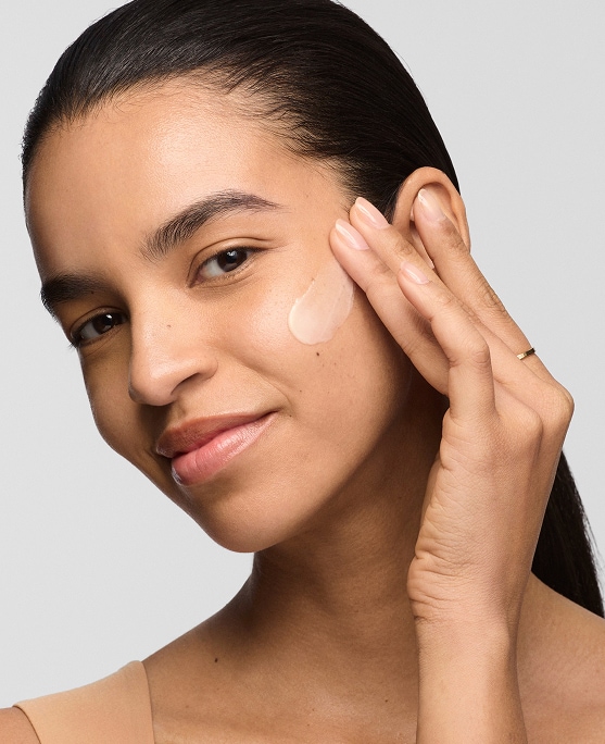 photo of woman with dry skin routine applying moisturizer to face
