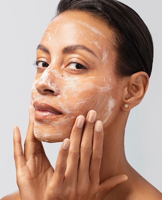 photo of woman using facial cleanser for skintype on face