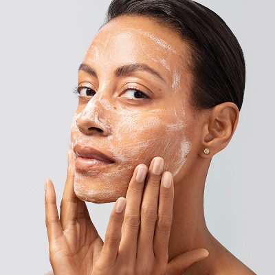 photo of woman using facial cleanser for skintype on face