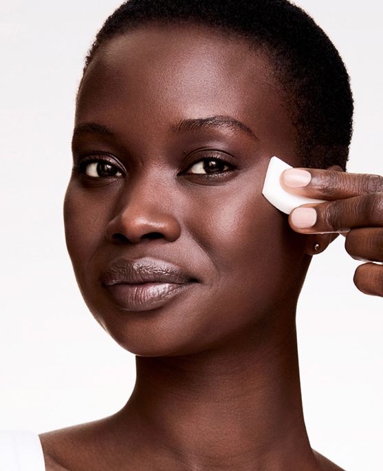 photo of woman applying double wear stay in place foundation that balances oil and hydration in skin