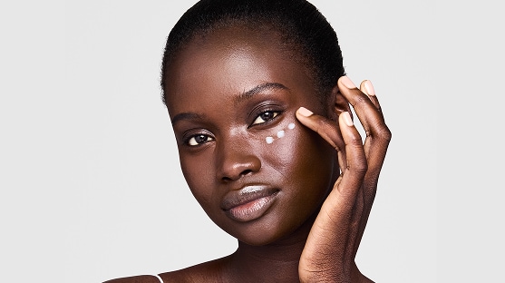 photo of woman applying eye cream to get rid of undereye wrinkles and lines