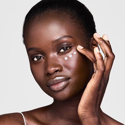 photo of woman applying eye cream to get rid of undereye wrinkles and lines