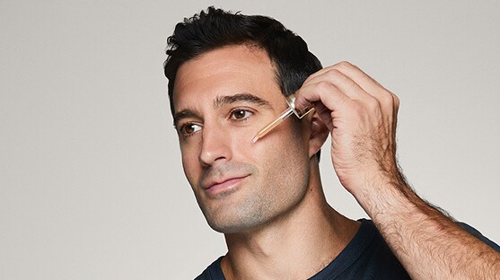 photo of man applying advanced night repair serum doing mens skincare routine