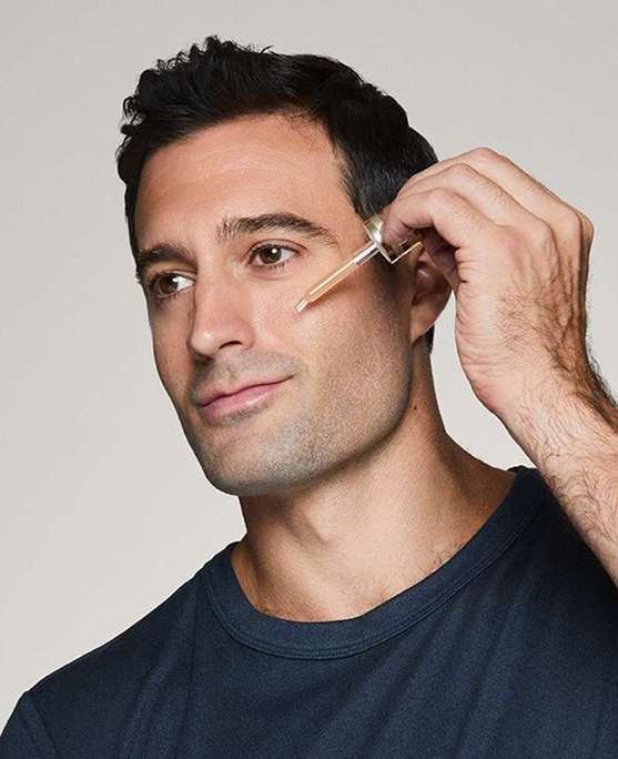 photo of man applying advanced night repair serum doing mens skincare routine
