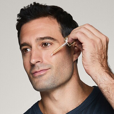 photo of man applying advanced night repair serum doing mens skincare routine