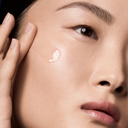 estee lauder model applying peptide skincare product