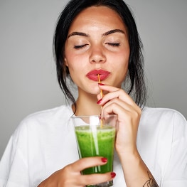 photo of woman drinking longevity smoothie
