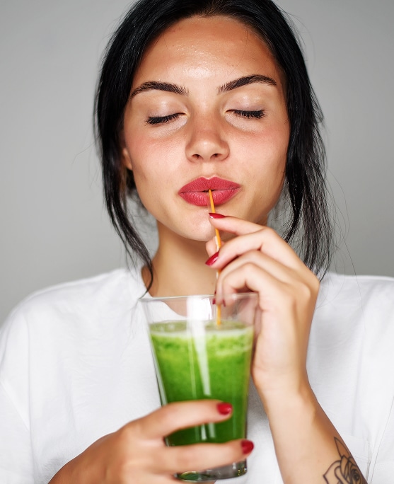 photo of woman drinking longevity smoothie
