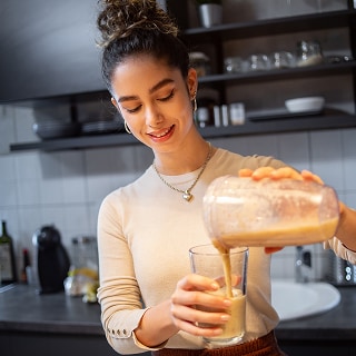 photo of woman drinking longevity smoothie