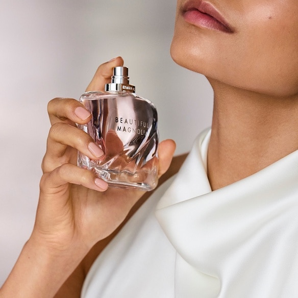 photo of woman applying estee lauder beautiful eau de parfum wedding fragrance